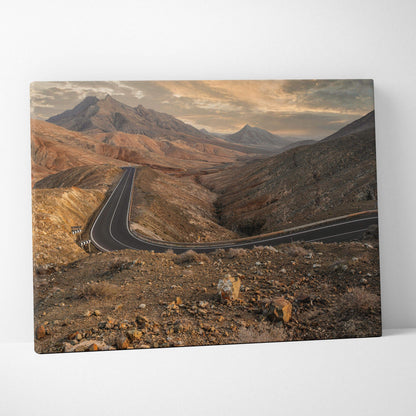 Desert mountains landscape canvas wall art featuring winding road and rocky terrain under cloudy sky.
