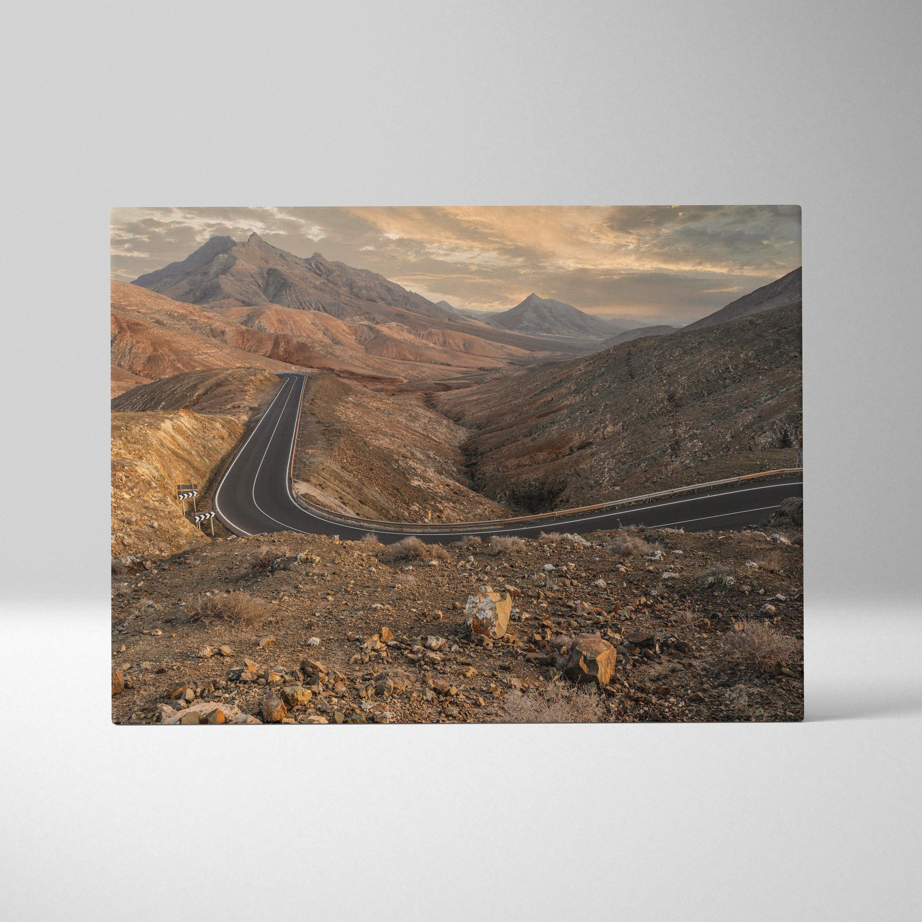 Desert mountains landscape with winding road canvas wall art in warm earthy tones.