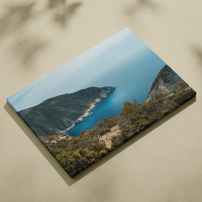 Mountain and ocean landscape canvas wall art with vibrant blue water and rugged cliffs.