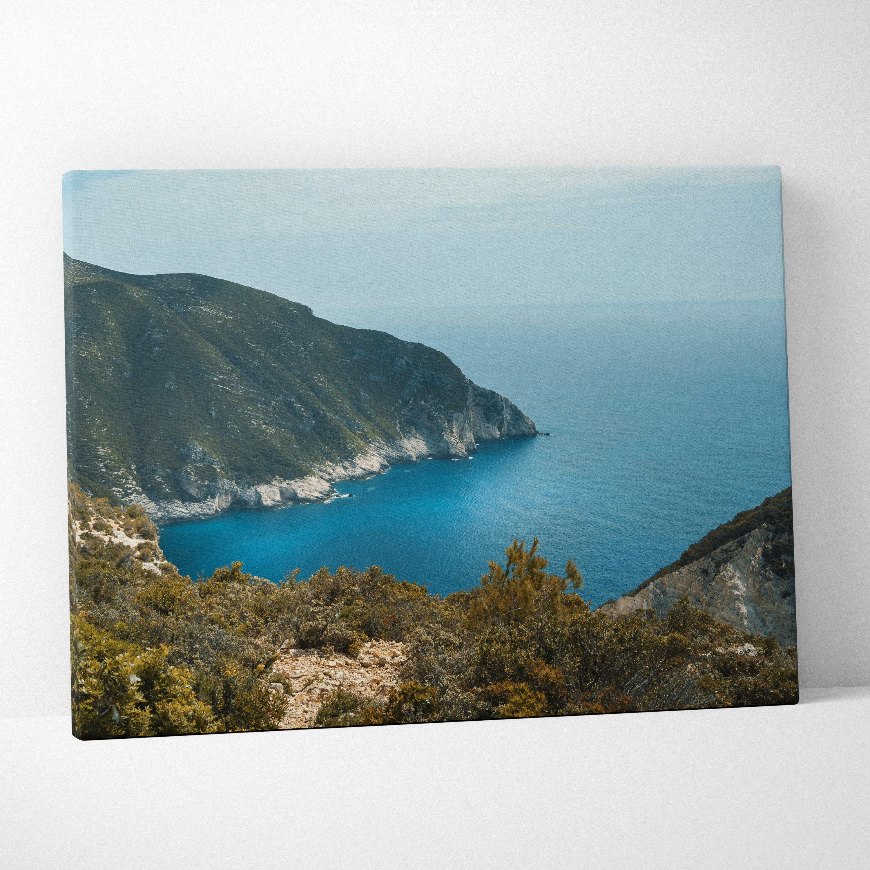 Mountain and ocean landscape canvas wall art with blue sea and rugged coastline.