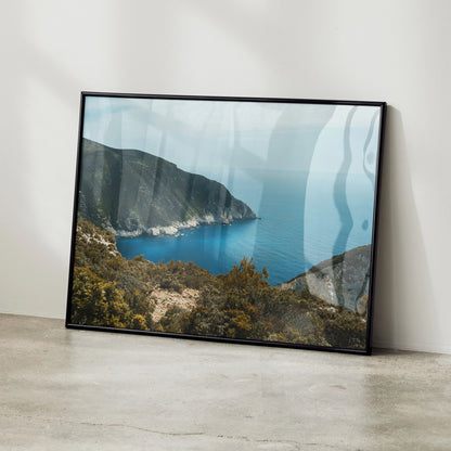 Coastal mountain landscape ocean view poster with blue sky wall art in black frame.