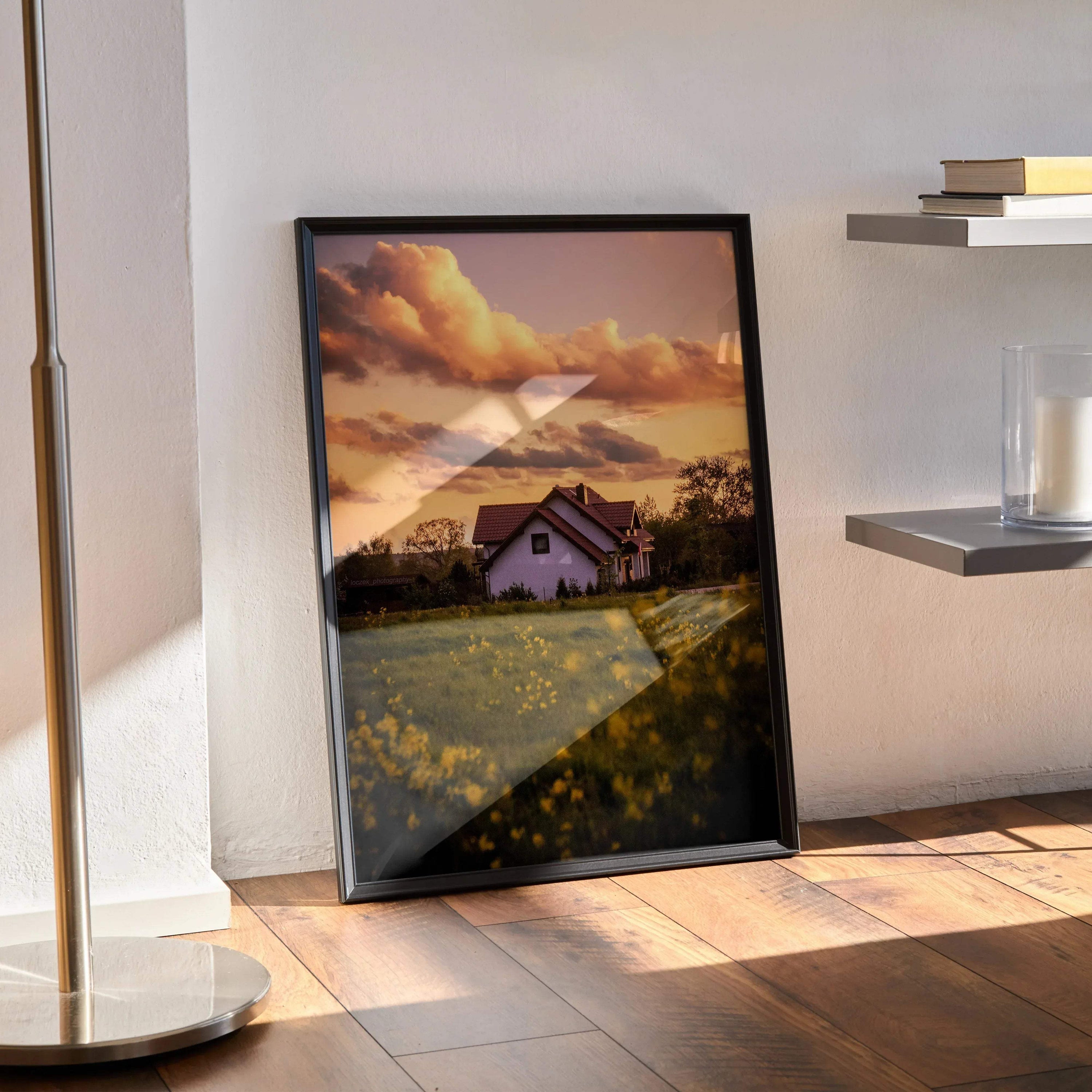 Vertical wall art poster featuring a sunset sky over a floral field and building in warm tones.