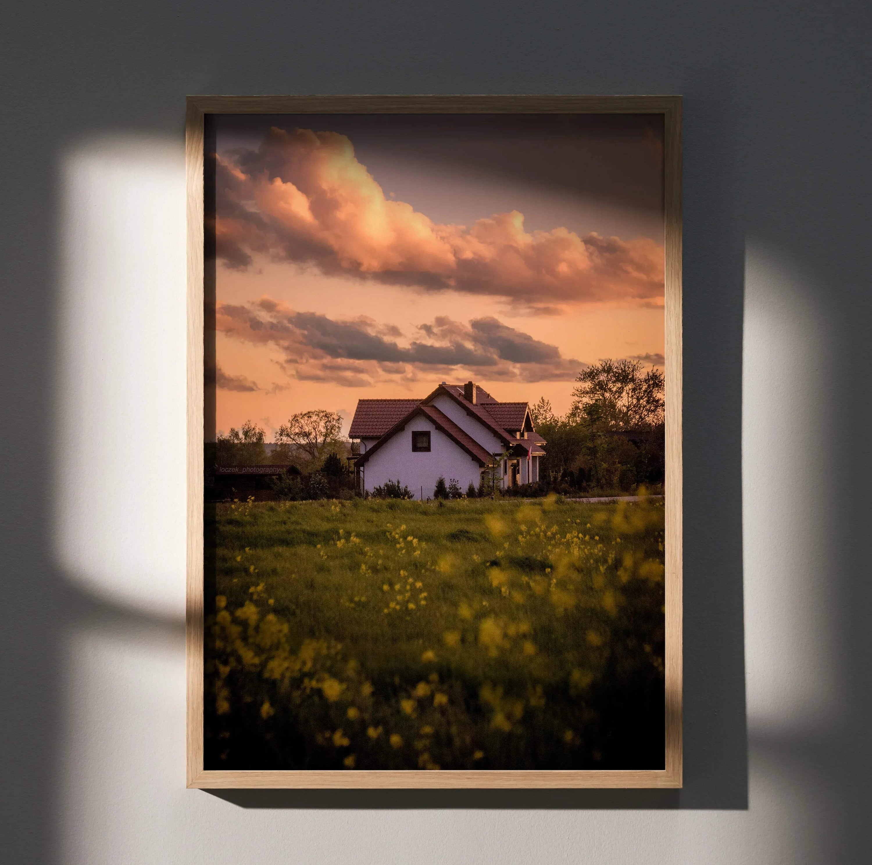 Sunset sky over white building with floral field foreground vertical wall art poster.