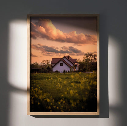 Sunset sky over white building with floral field foreground vertical wall art poster.