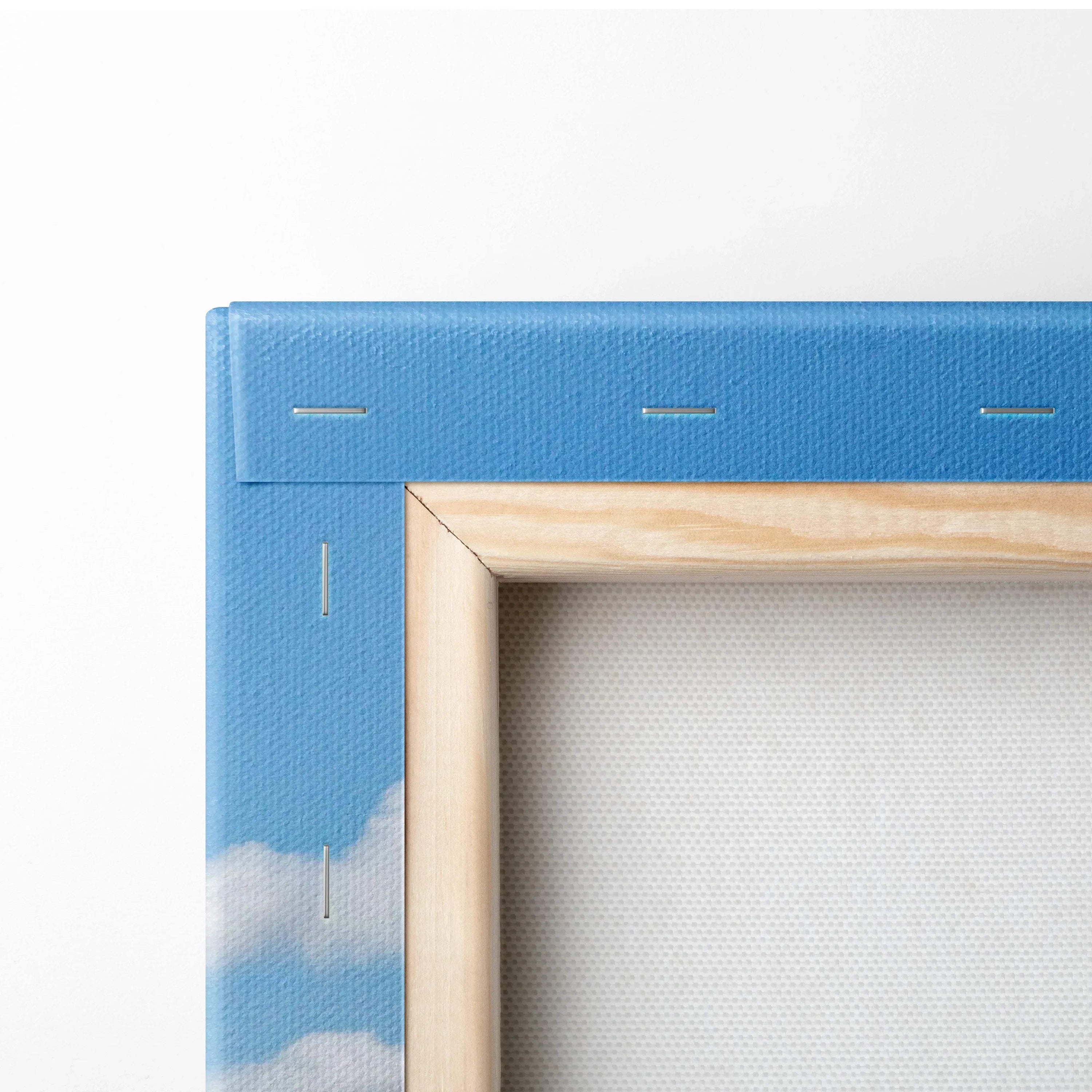 Close-up of canvas wall art corner with blue sky and white clouds and wooden frame detail.