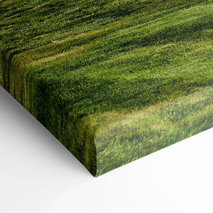 Green grassy field landscape printed on wrapped canvas wall art corner close-up.