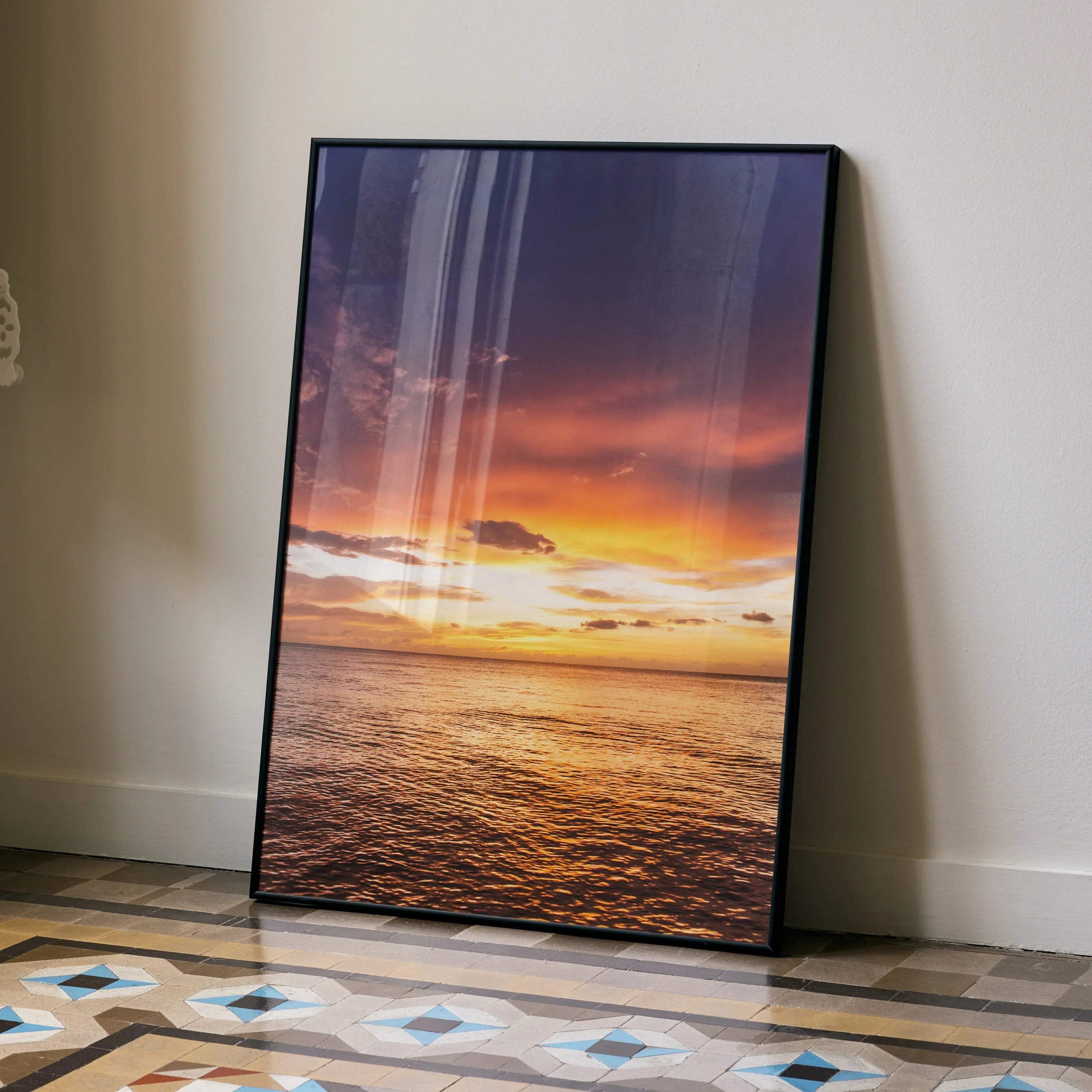 Ocean sunset poster with vibrant orange and purple sky reflected on calm water, vertical wall art.