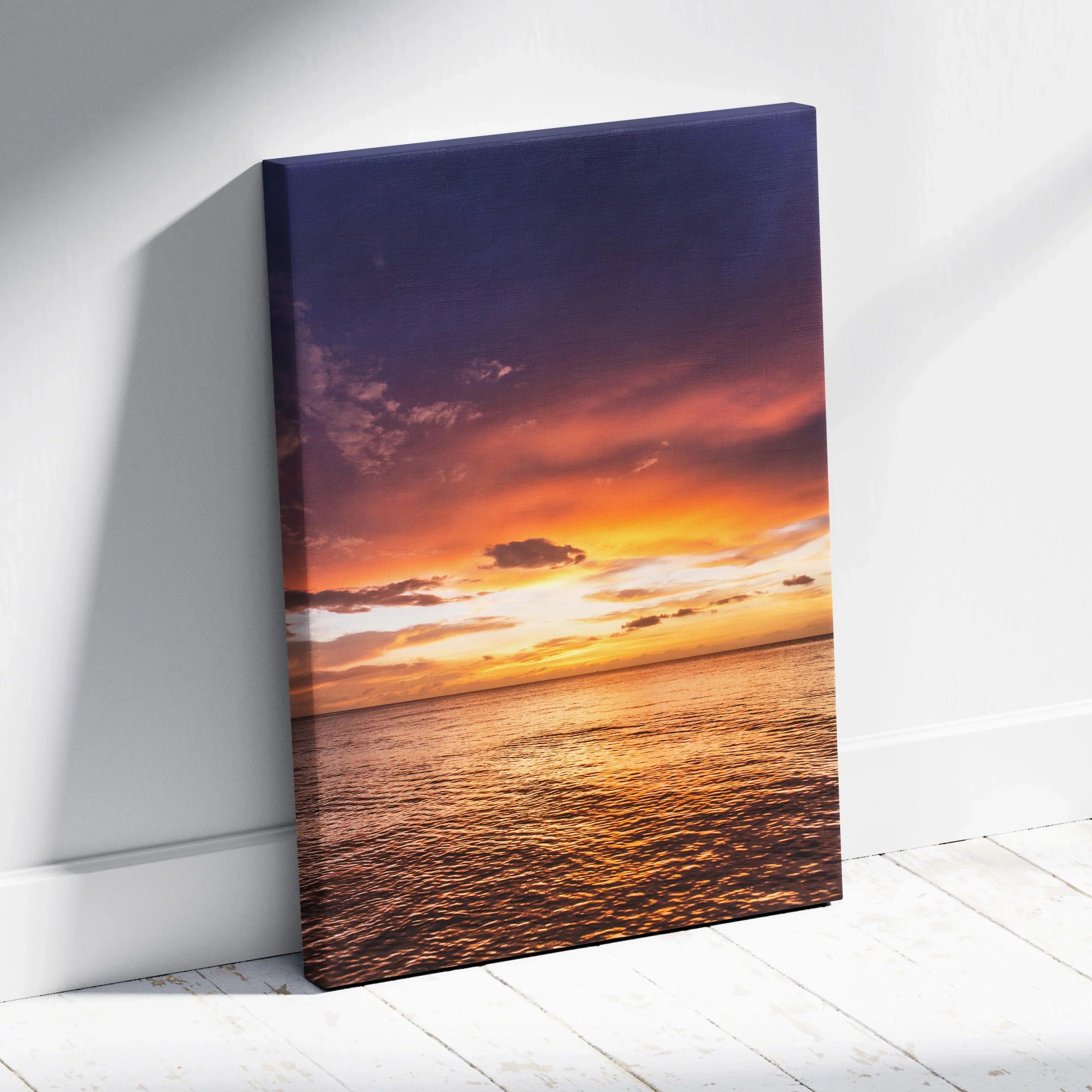 Ocean sunset scene with vibrant orange and purple sky on vertical canvas wall art.