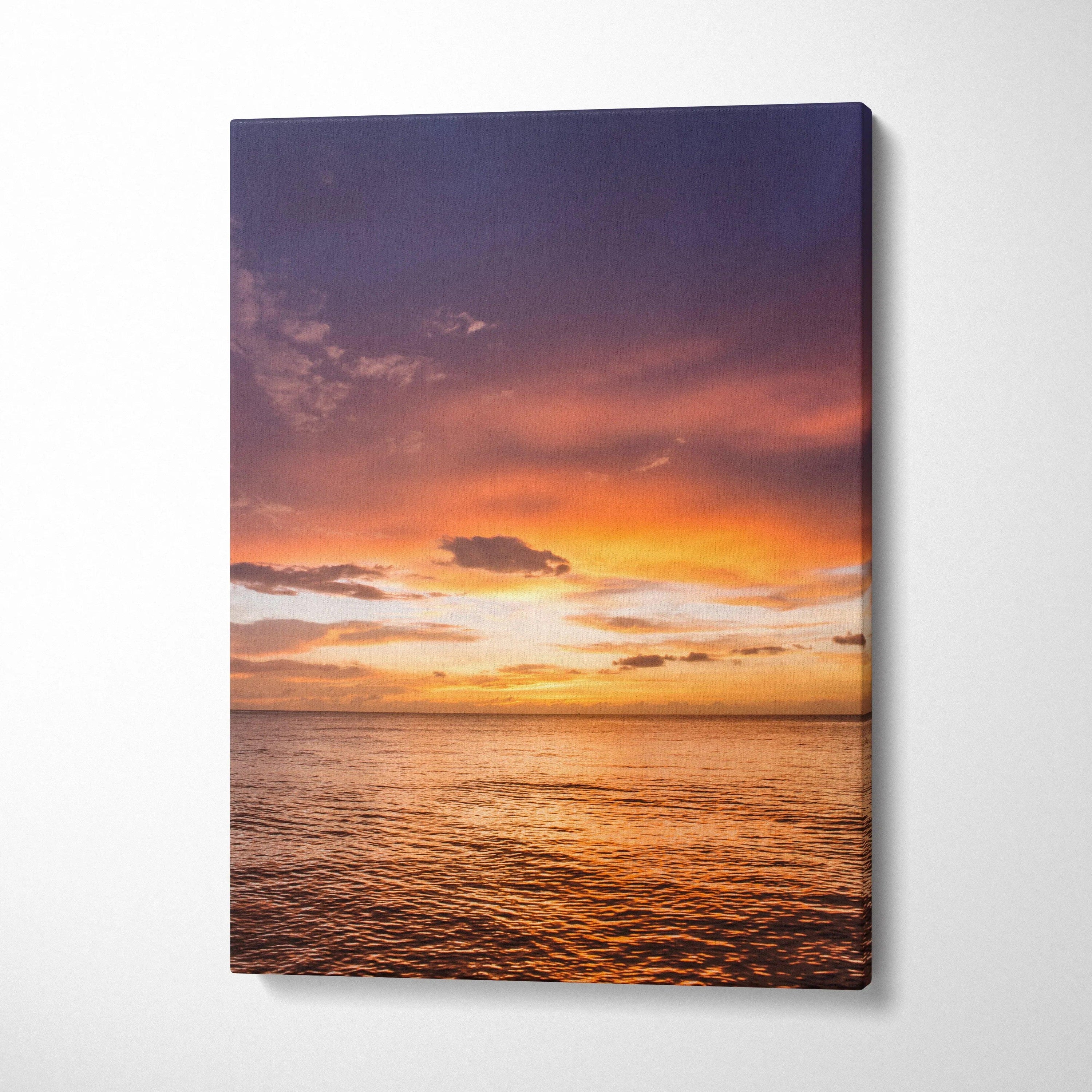Ocean sunset canvas wall art with vibrant orange and purple sky over calm water.