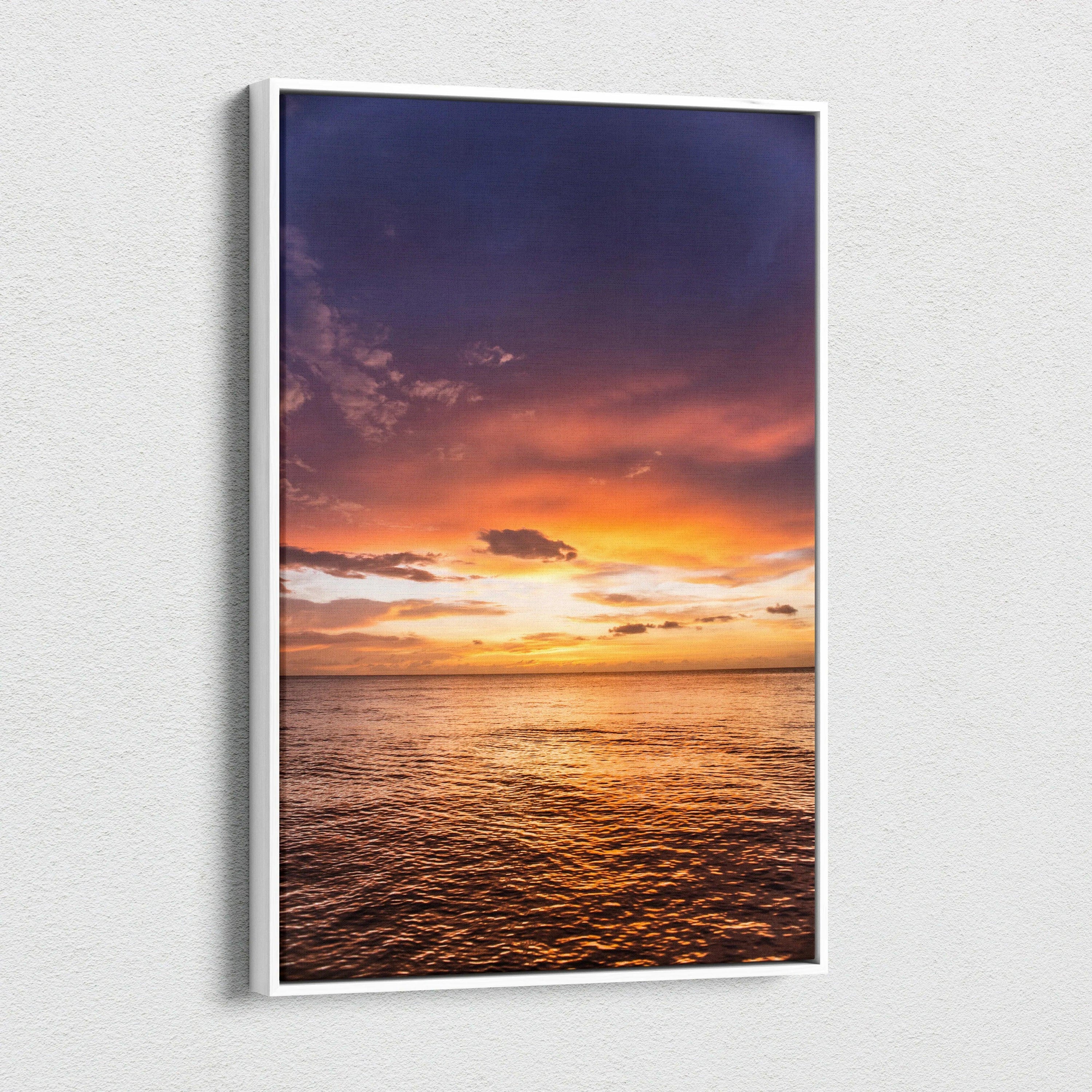 Ocean sunset scene on vertical canvas wall art with vibrant orange and purple sky.