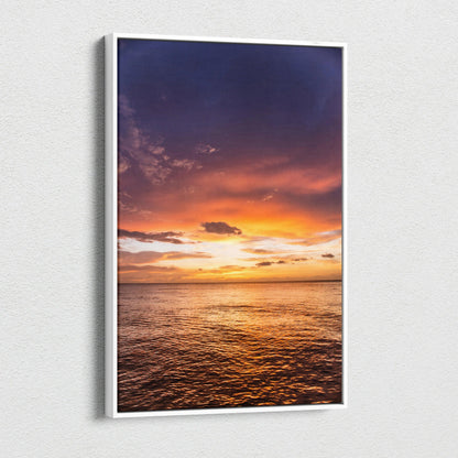 Ocean sunset scene on vertical canvas wall art with vibrant orange and purple sky.