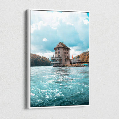 Vertical canvas wall art of a large house on water with a cloudy sky background.