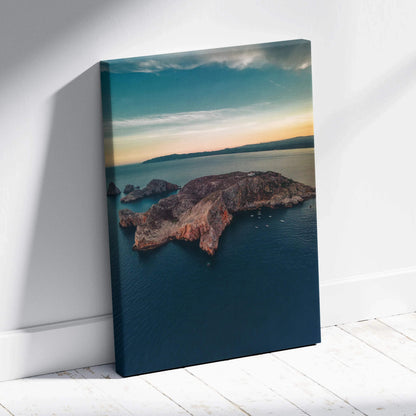 Canvas wall art featuring a tranquil beach landscape with rocky mountains under a soft sunset sky.