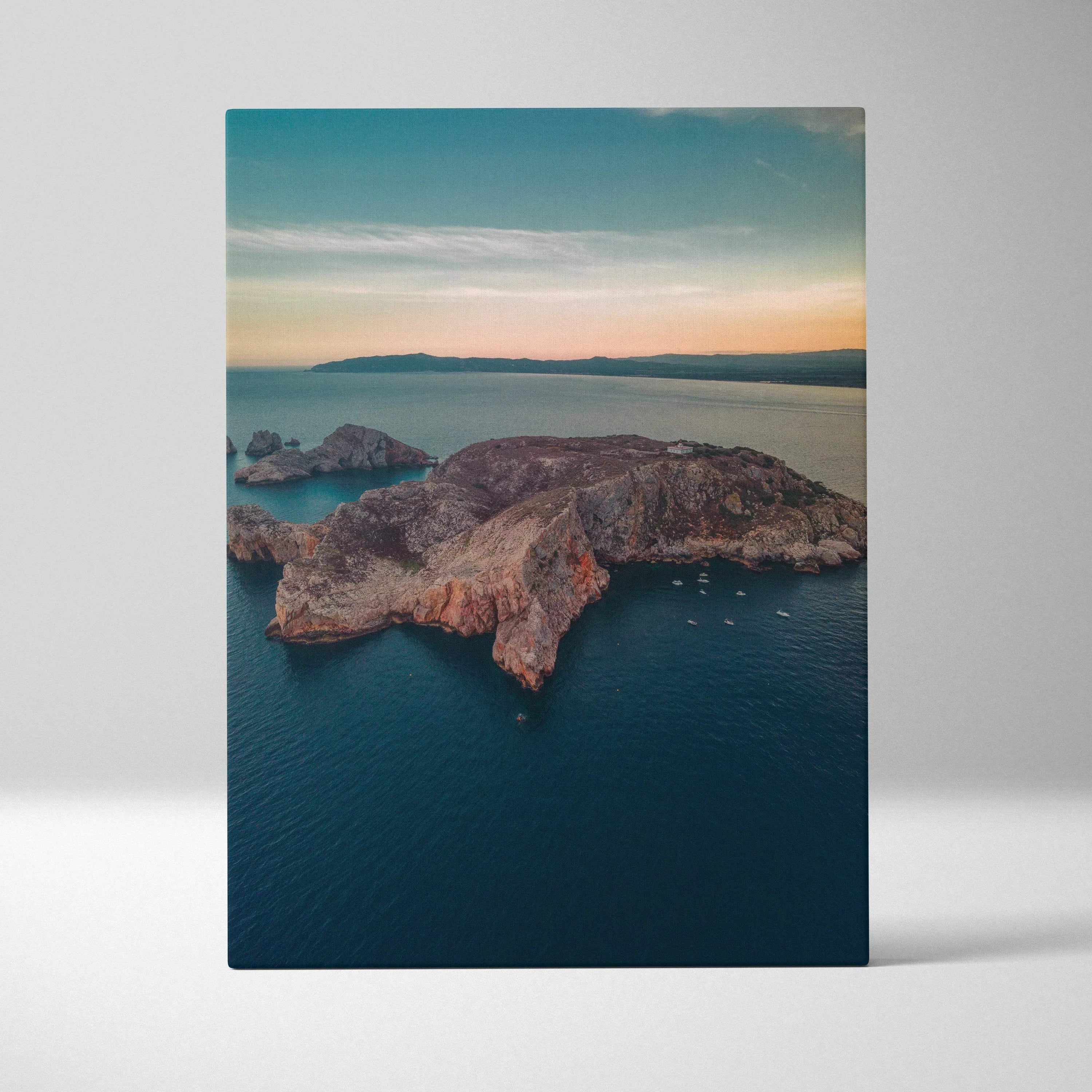 Canvas wall art featuring a tranquil beach and rugged mountain landscape at sunset.