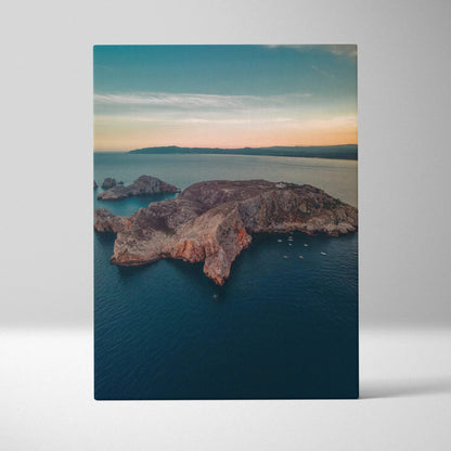 Canvas wall art featuring a tranquil beach and rugged mountain landscape at sunset.