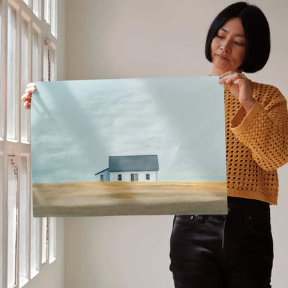 Minimalist modern urban building digital art poster held by woman, soft muted tones, wall art.