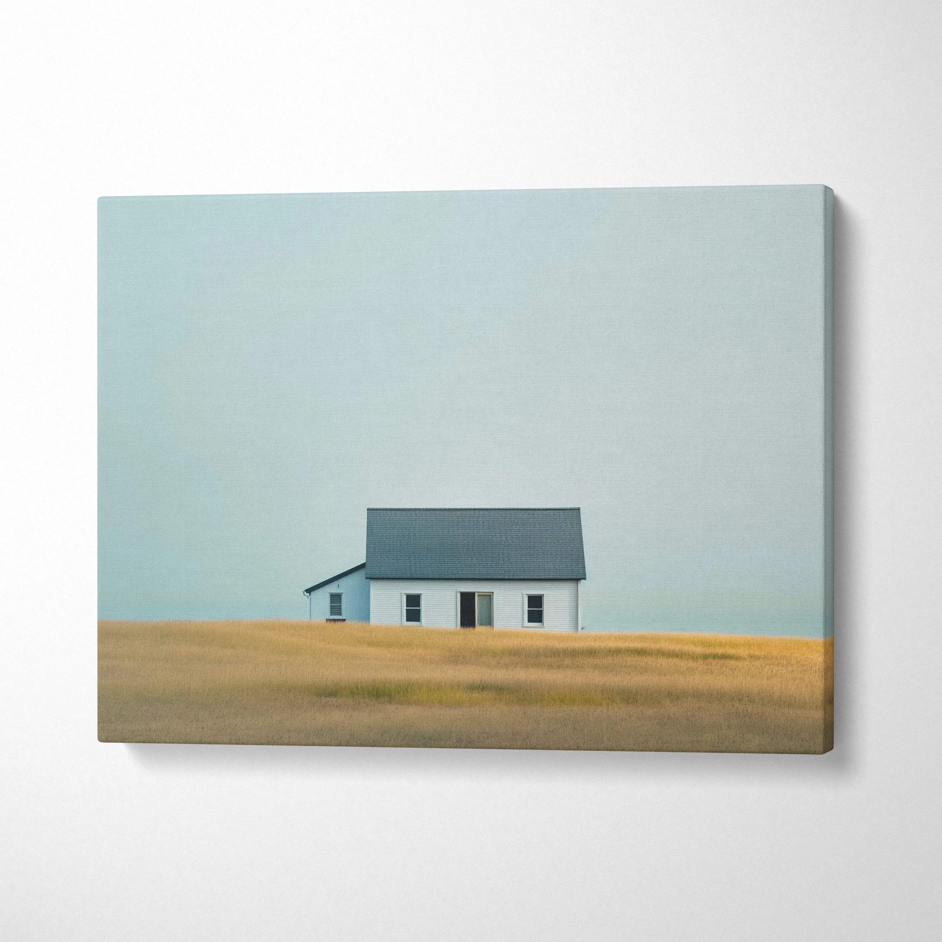 Minimalist canvas wall art featuring a solitary house in a golden field under a pale blue sky.