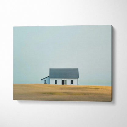 Minimalist canvas wall art featuring a solitary house in a golden field under a pale blue sky.