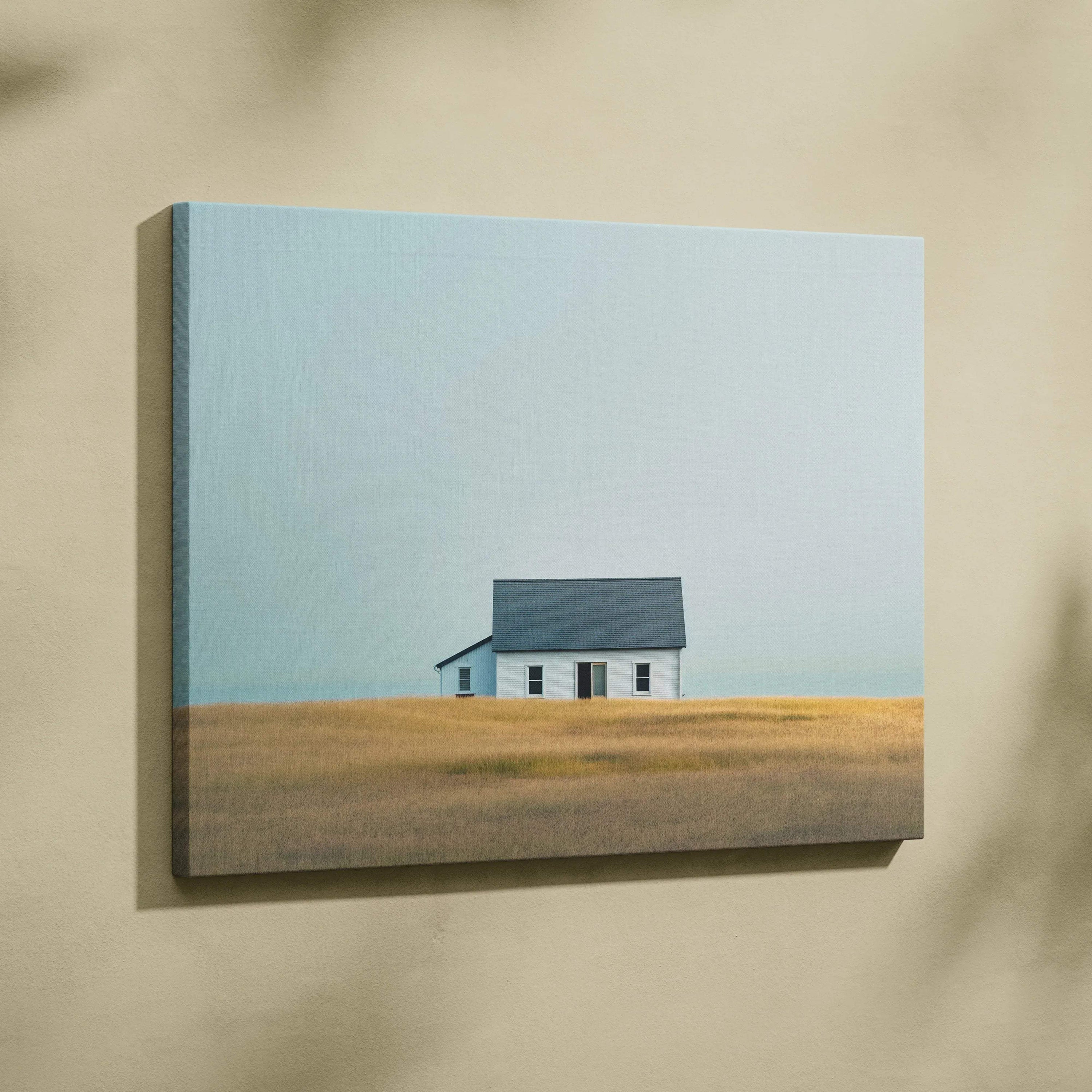 Canvas wall art featuring minimalist house in golden field under pale blue sky.