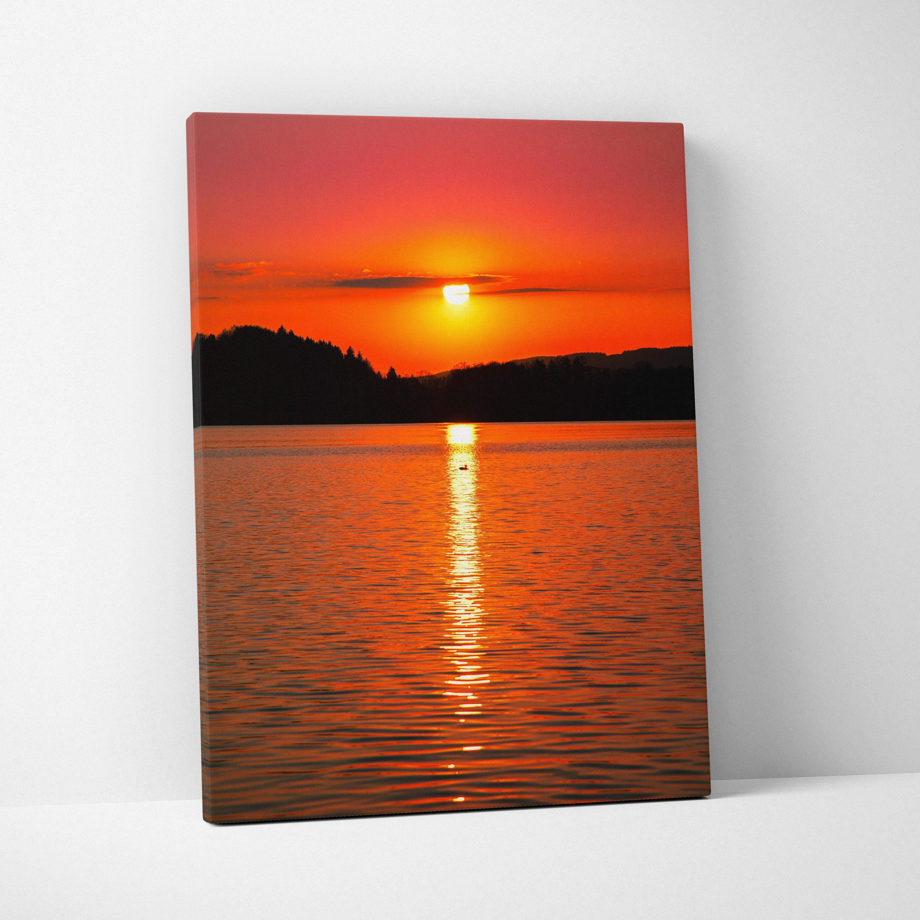 Vivid ocean sunset canvas wall art with glowing orange sun reflecting on calm water.