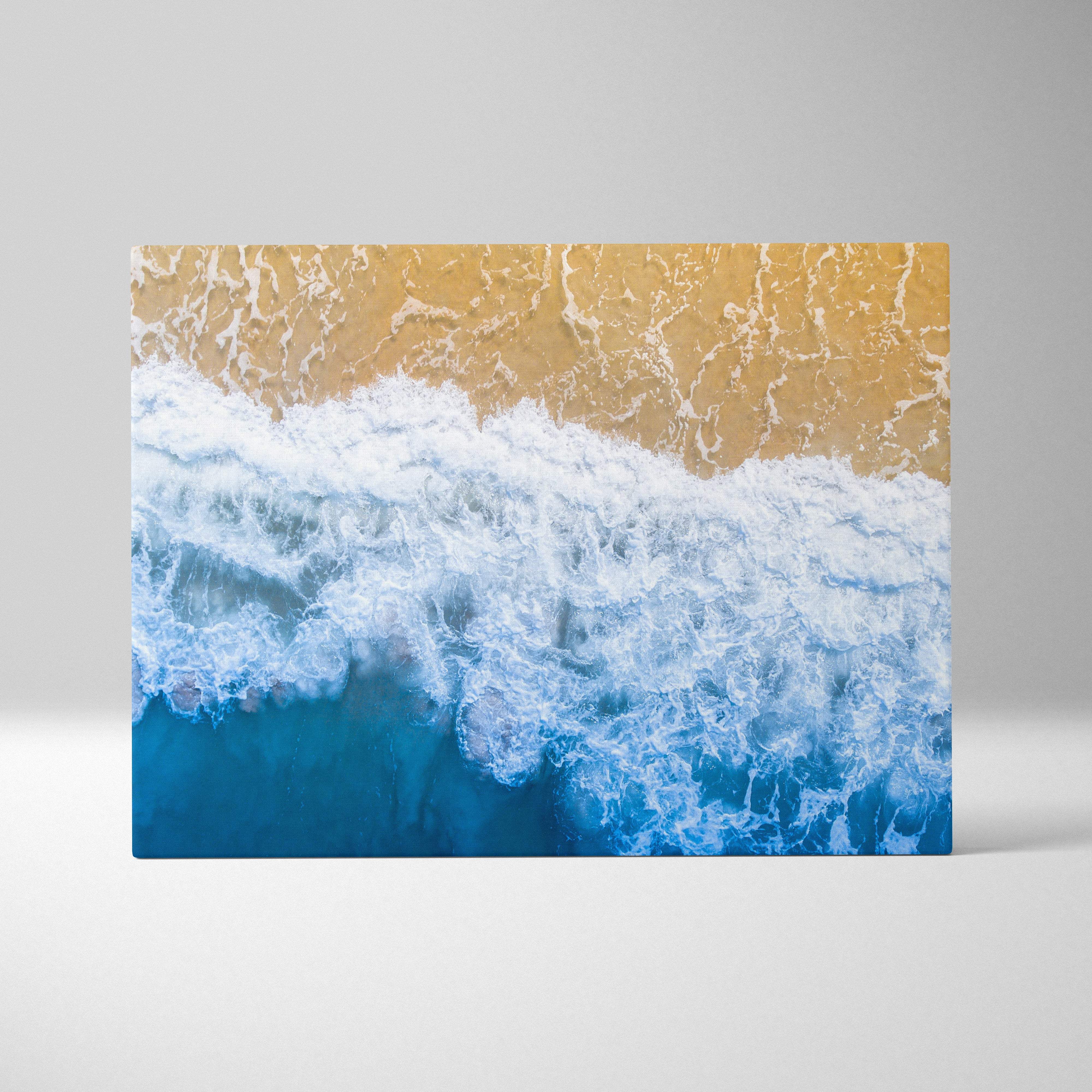 Beige and blue ocean wave canvas print featuring aerial shore photography for coastal living room or beach house decor