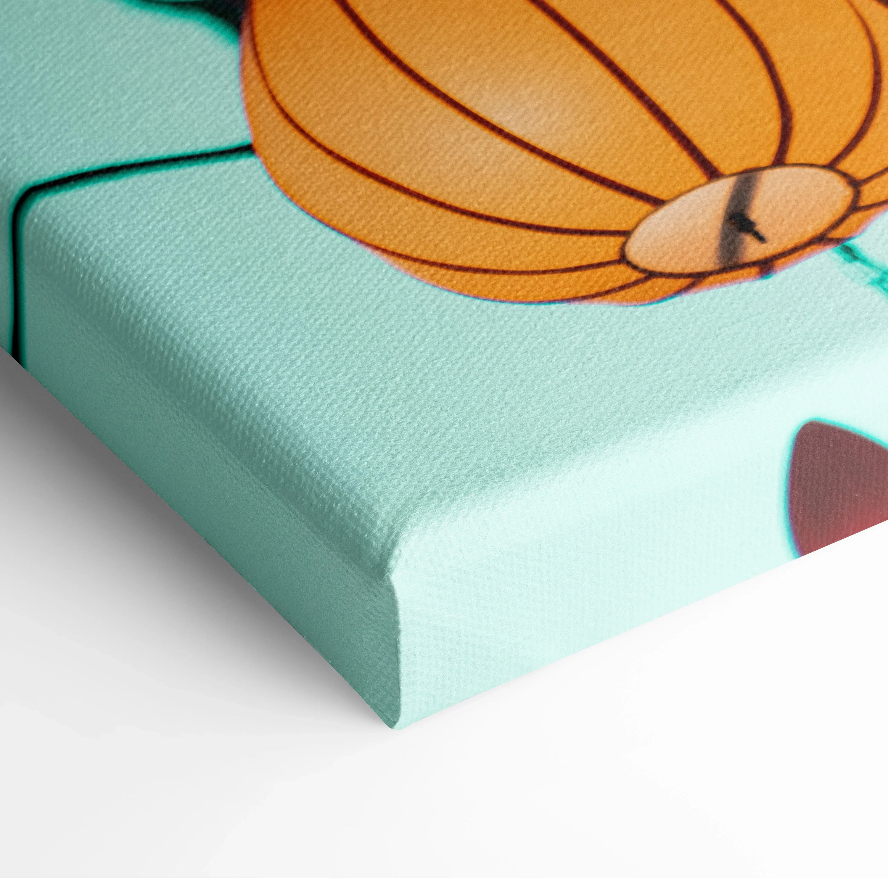 Close-up of turquoise canvas wall art corner with orange hot air balloon detail and textured surface.
