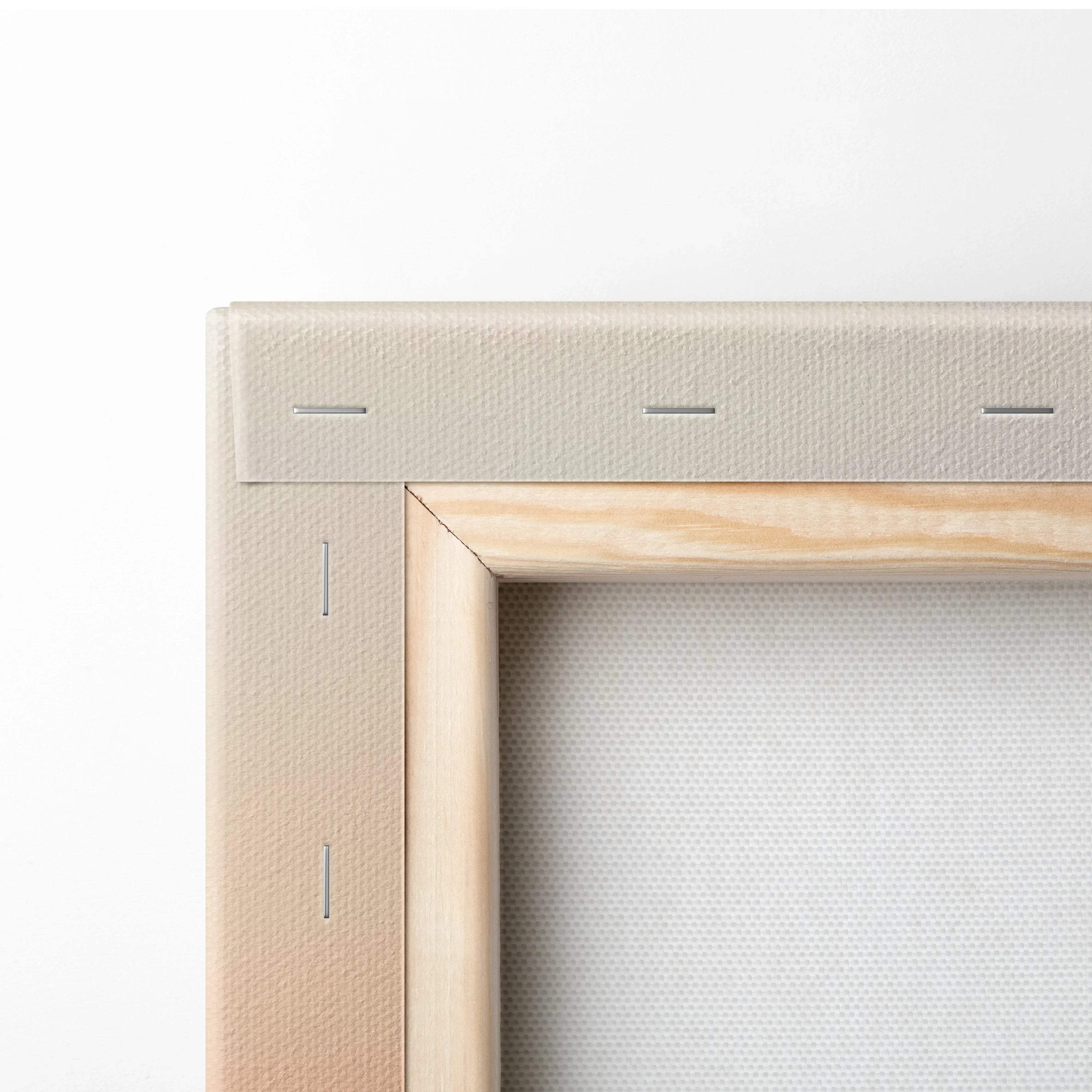 Back of beige canvas with light wood frame over misty mountain valleys at dawn