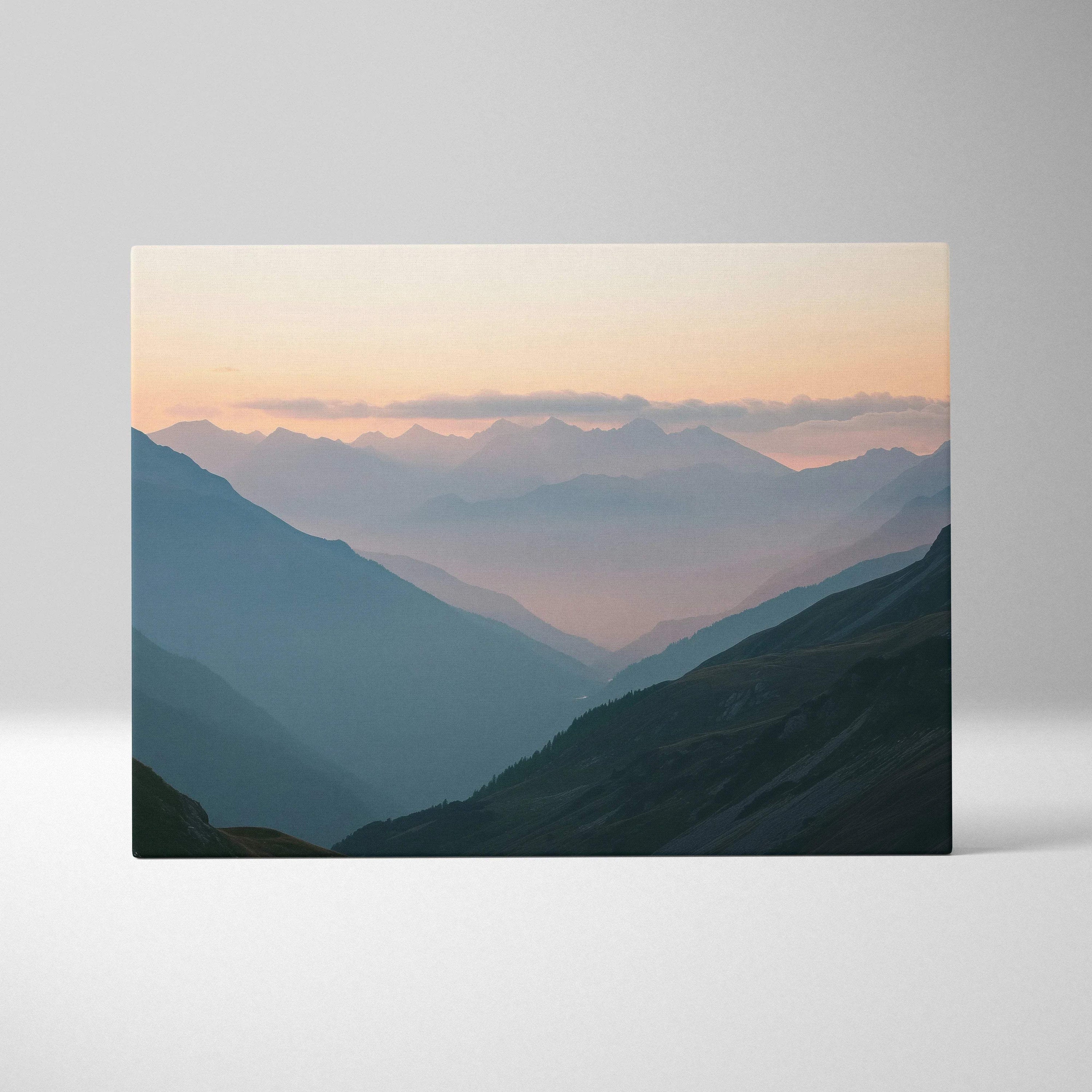 Serene mountain landscape canvas print with misty valleys at dusk in blues and peach sky