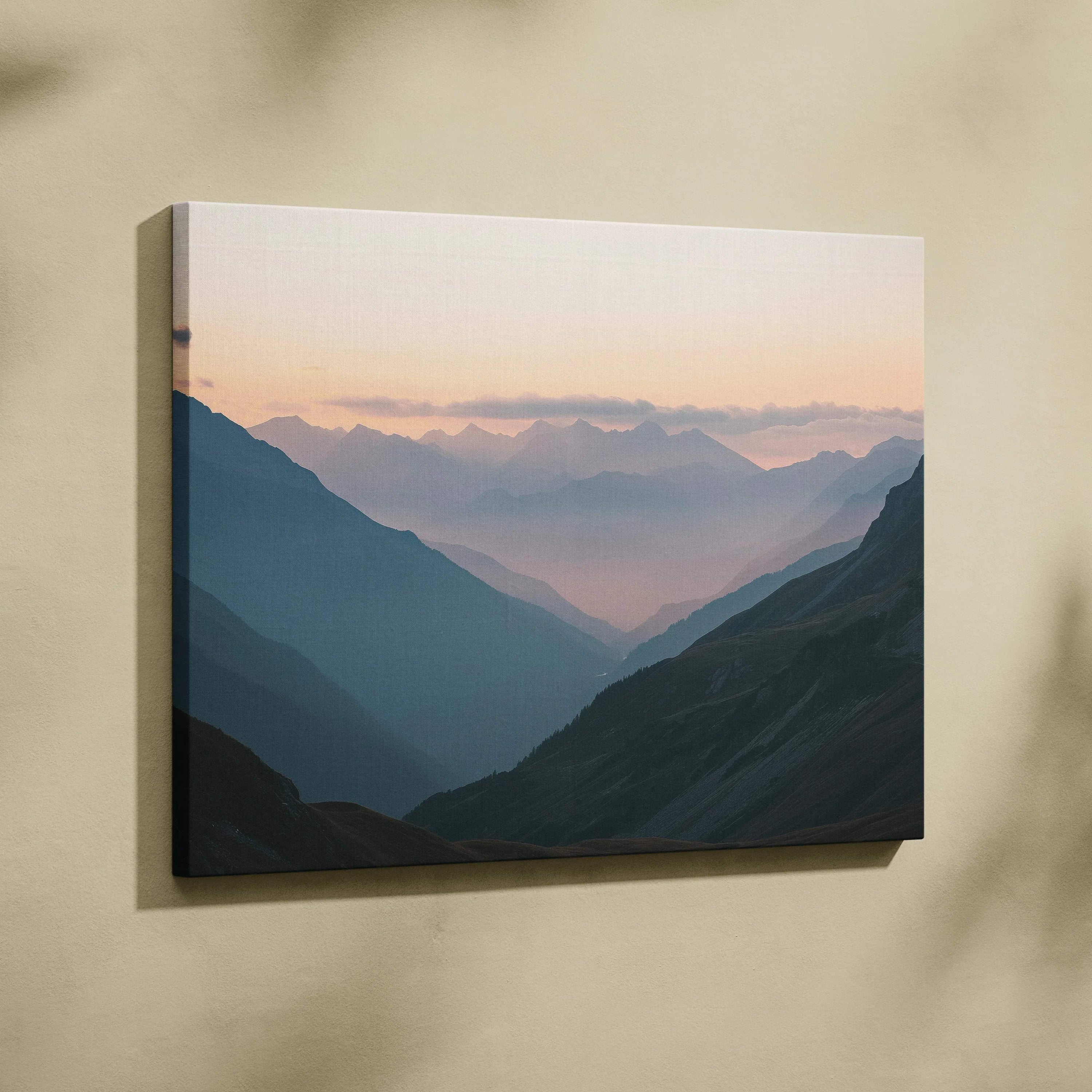 Serene mountain landscape canvas print with misty valleys at dawn in muted blues and peach sky