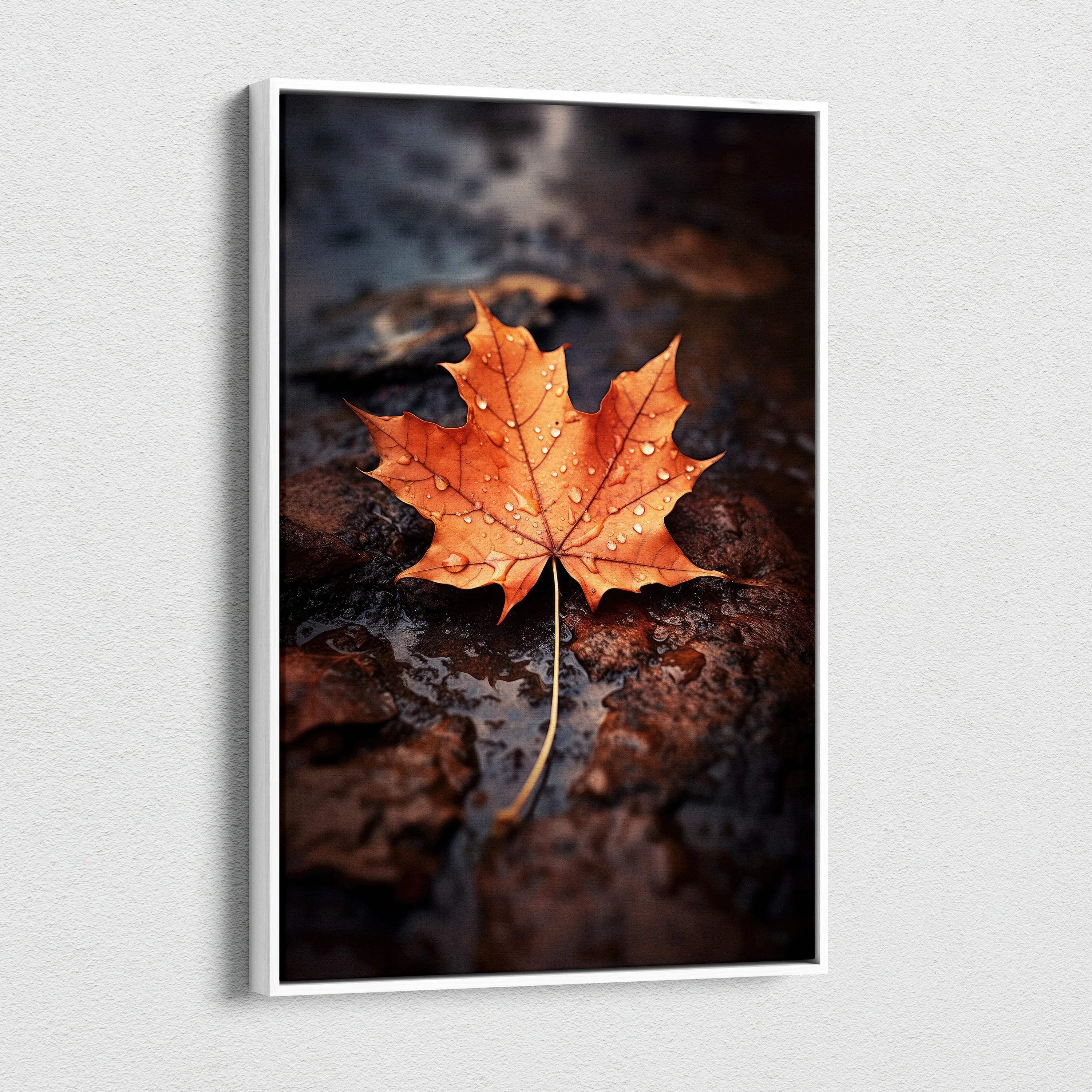 Canvas wall art featuring a vibrant orange autumn maple leaf on dark wet ground.