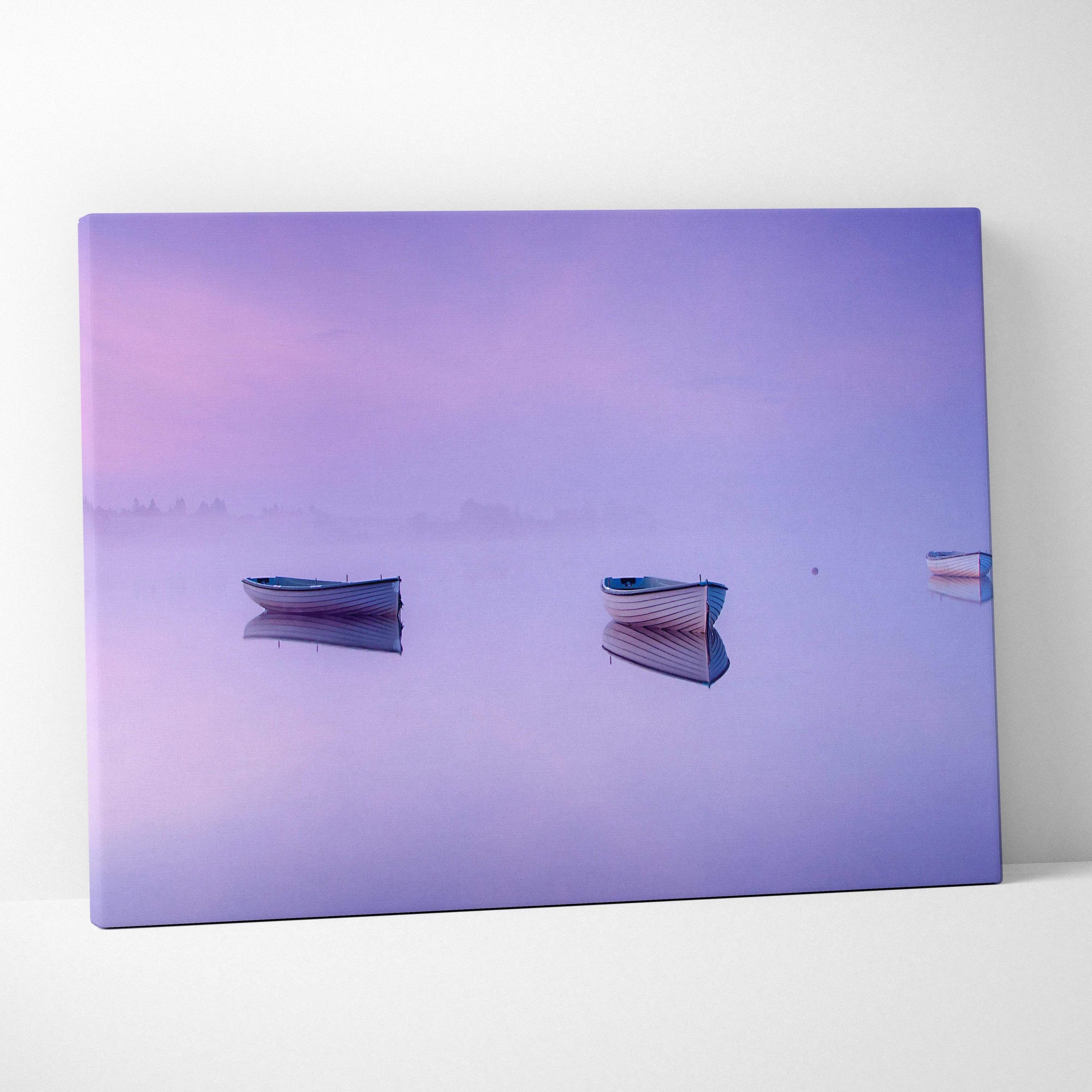 Purple canvas print of three boats on foggy mirror lake in lilac pink blue tones