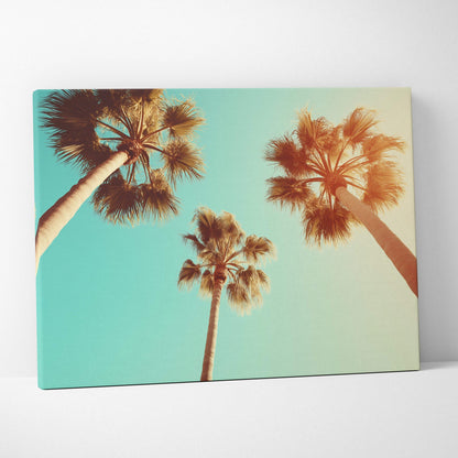 Canvas wall art featuring three tall palm trees against a bright turquoise sky.