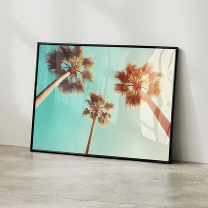 Serene beach digital art poster featuring tall palm trees against a blue sky, modern wall art framed in black.