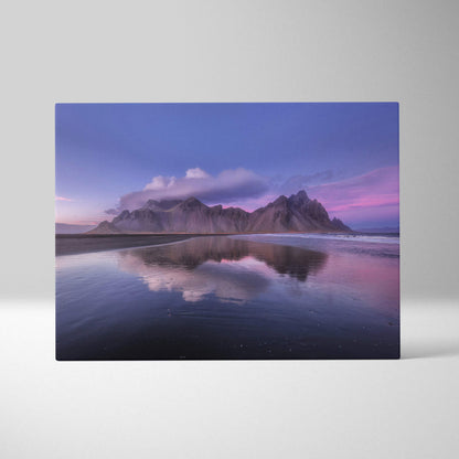 Iceland mountain beach canvas wall art print showing purple sunset reflection of rugged mountains on calm water
