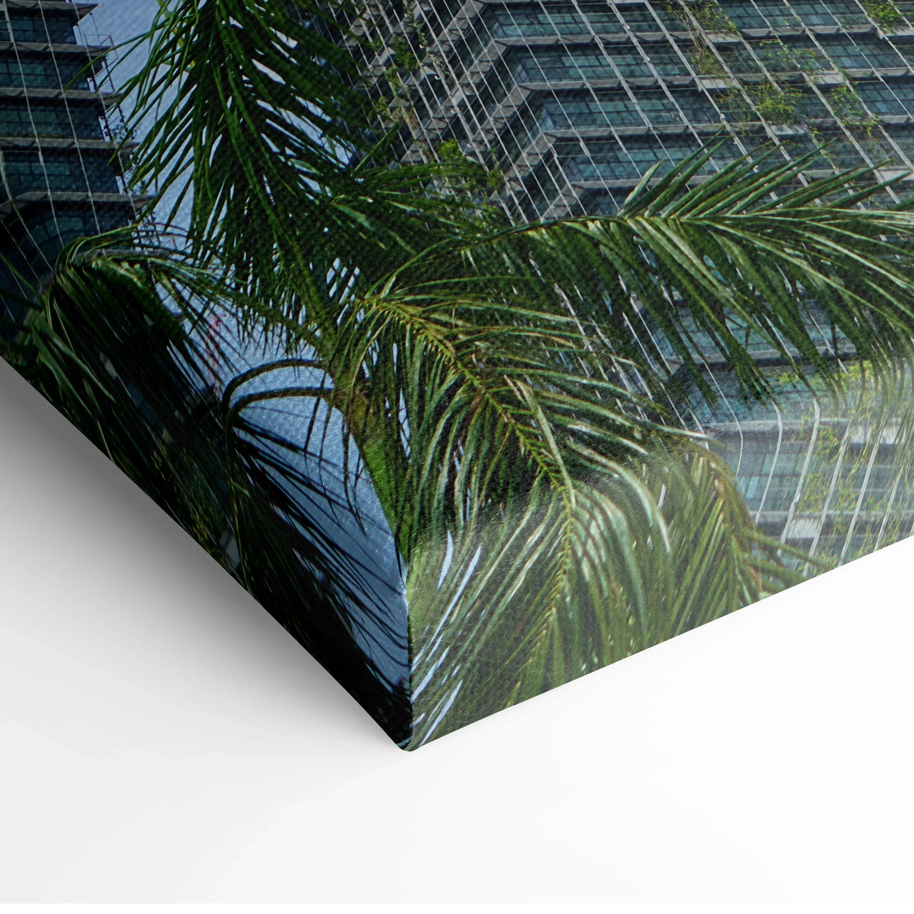 Urban architecture canvas wall art featuring palm leaves and modern buildings detail.