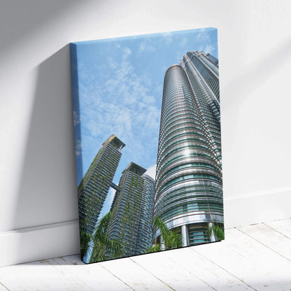 Vertical canvas wall art featuring modern urban skyscrapers under a blue sky.