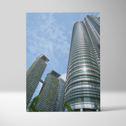 Vertical canvas wall art featuring modern high-rise buildings against a blue sky.