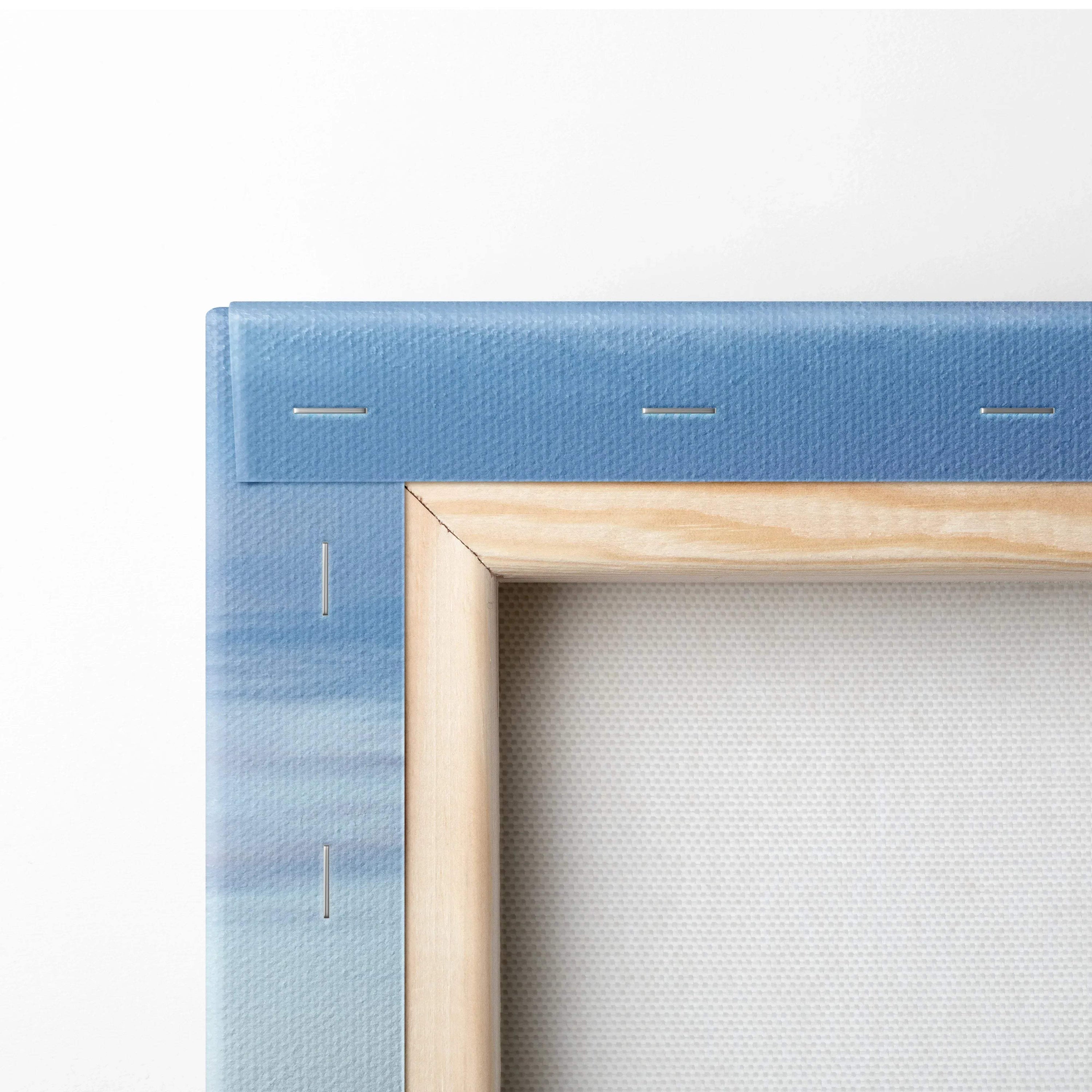Close-up of blue sky canvas stretched on wooden frame showing corner stapling for wall art print.