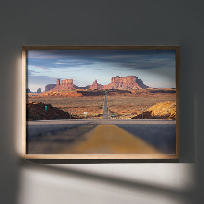 Majestic mountain landscape poster with open desert road, warm tones wall art in wooden frame.