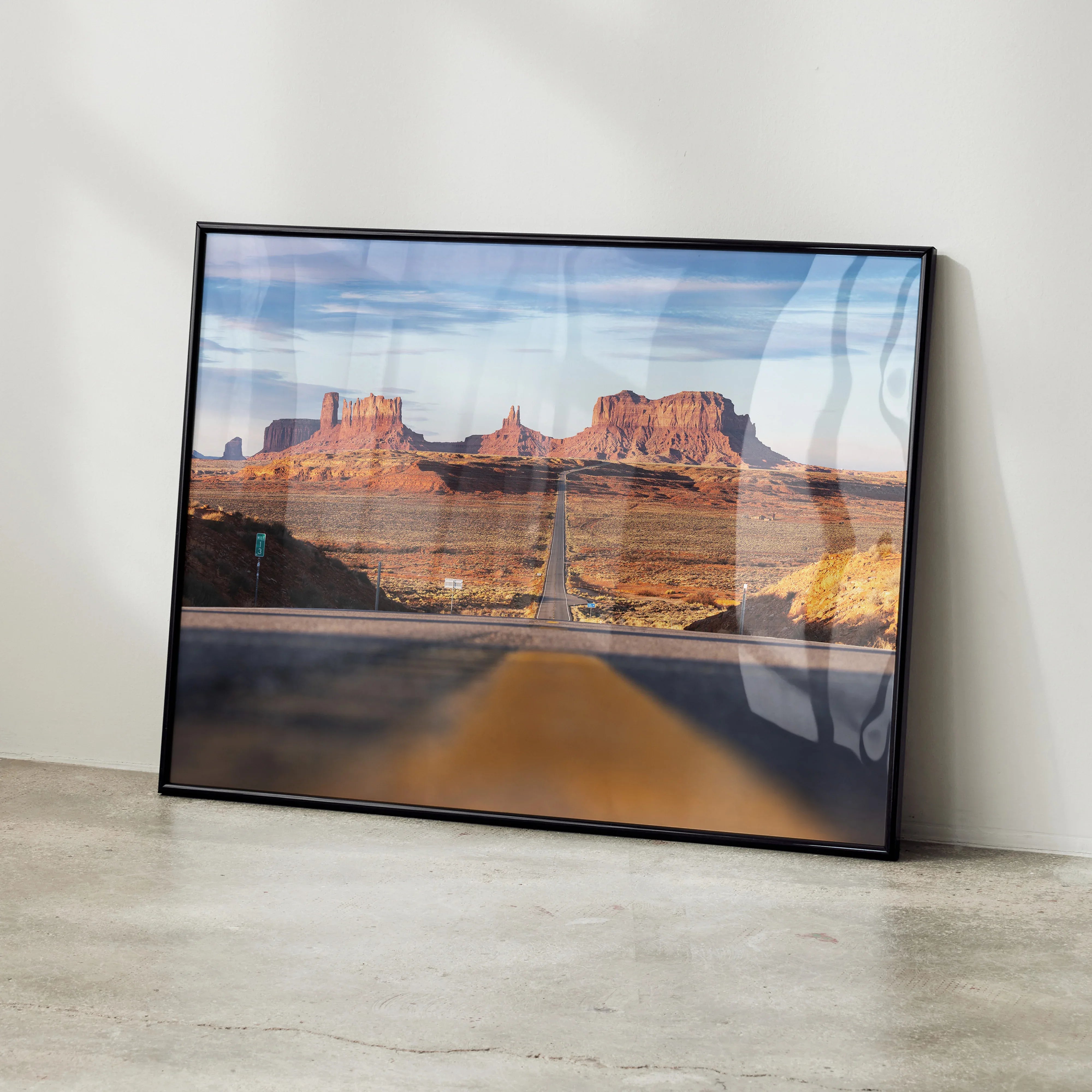 Majestic mountain landscape poster with desert rock formations and blue sky, wall art in black frame.