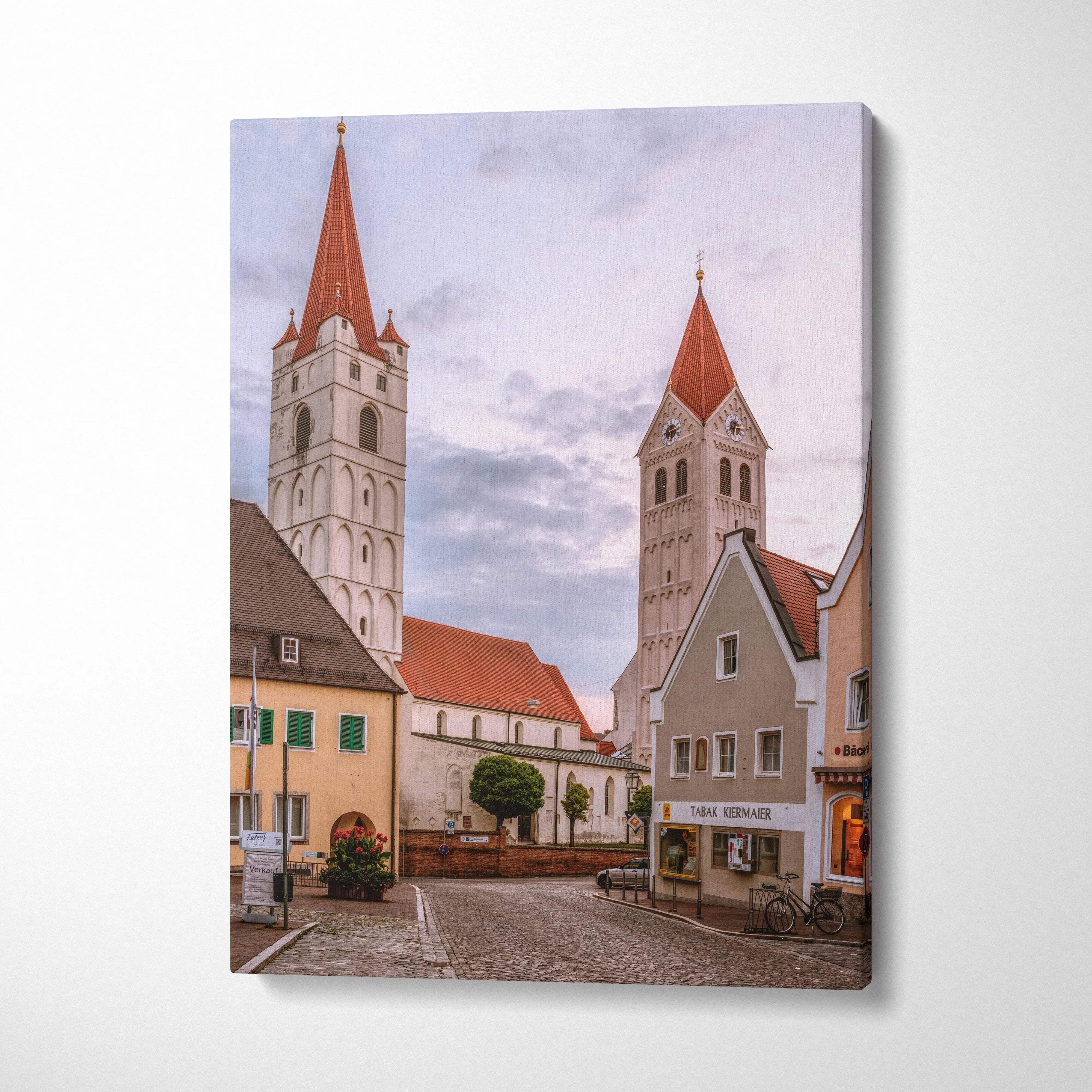 Modern urban skyline canvas wall art featuring historic European buildings with red roofs and a cloudy sky backdrop.
