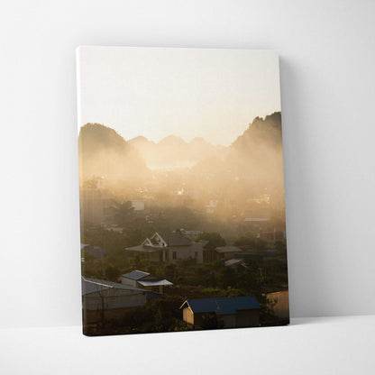 Canvas wall art featuring a misty mountain landscape at sunrise with soft golden light.