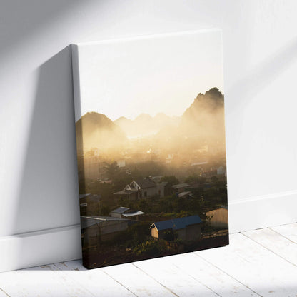 Sunlit mountain landscape canvas wall art with mist and village houses in soft gold tones.