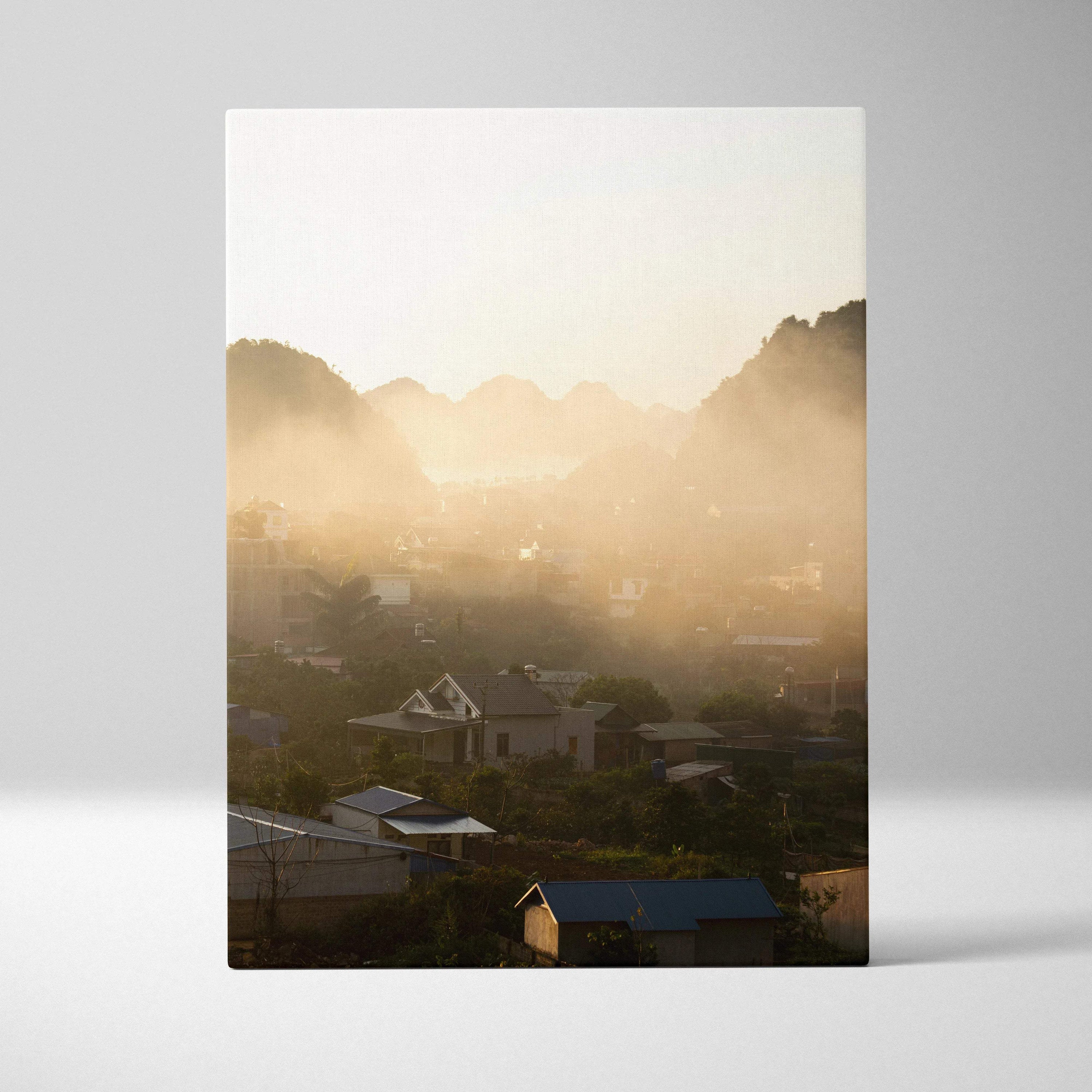 Vertical canvas wall art of misty mountain landscape with village at sunrise.