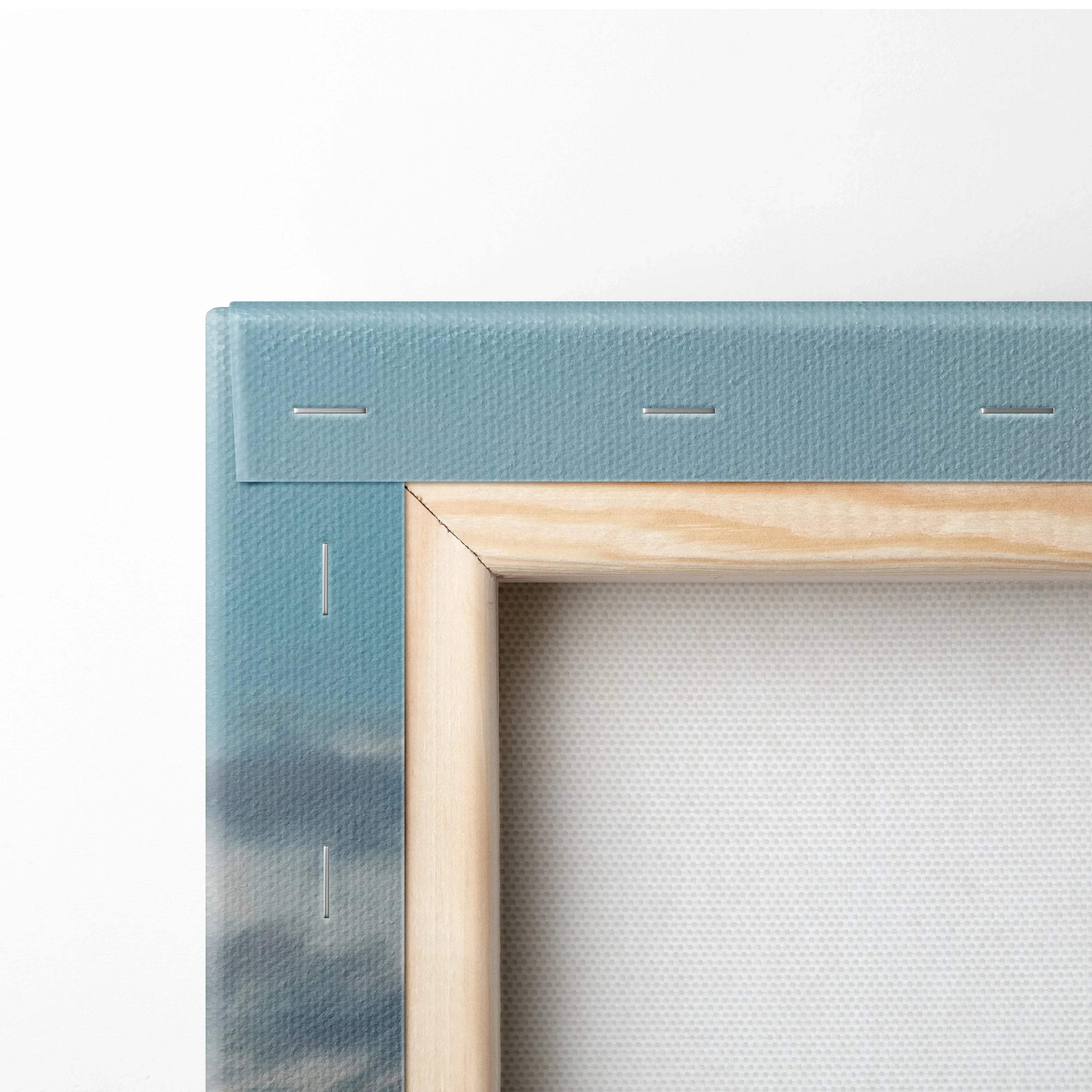 Close-up of canvas wall art showing wooden stretcher bars and blue printed edge with subtle mountain details.
