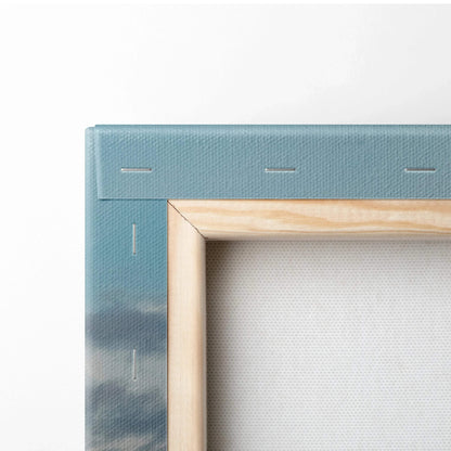 Close-up of canvas wall art showing wooden stretcher bars and blue printed edge with subtle mountain details.