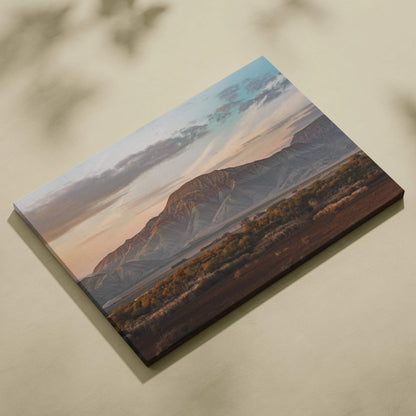 Canvas wall art featuring a majestic mountain and desert landscape at sunset with soft clouds.