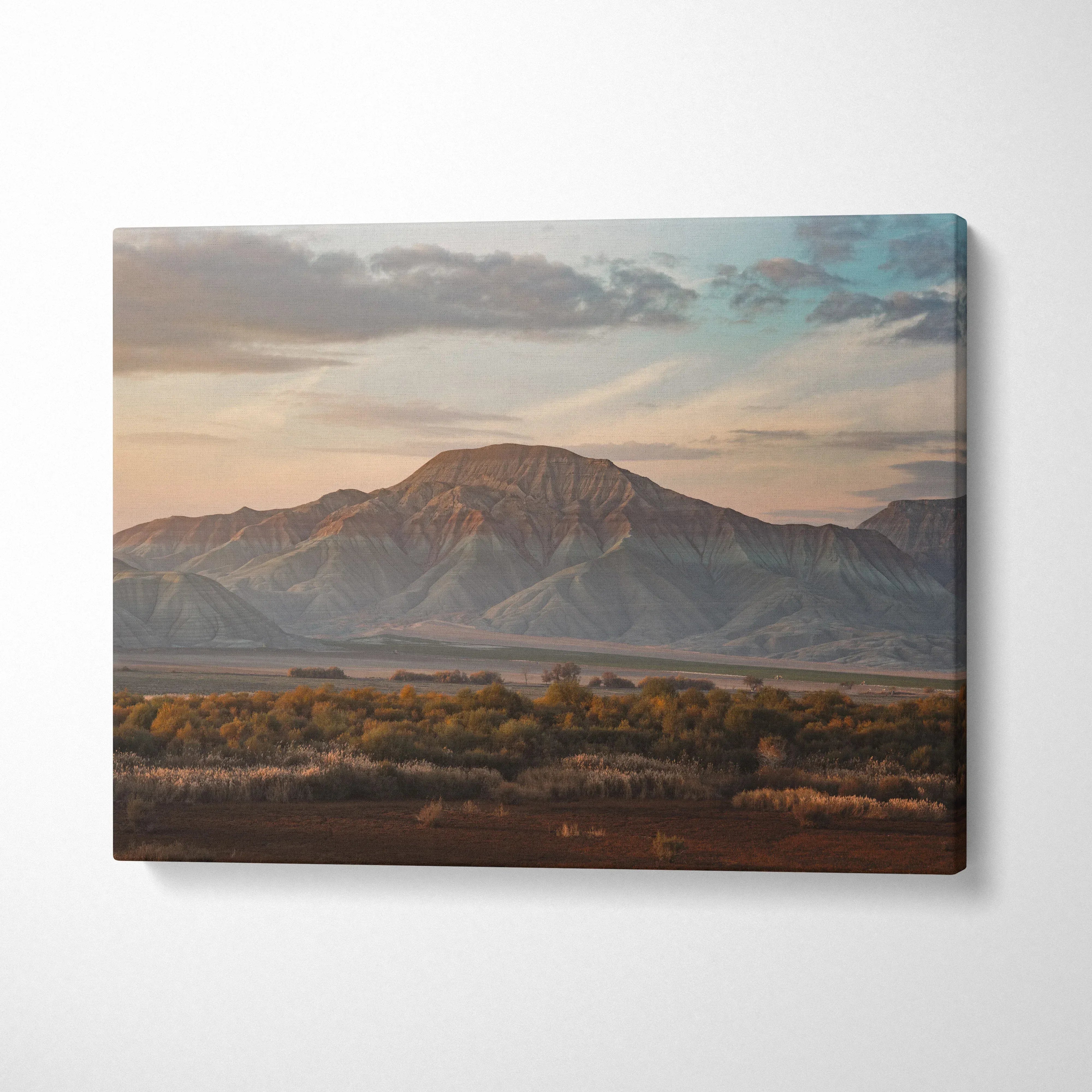 Canvas wall art featuring a majestic mountain and desert landscape at sunset with soft pastel skies.