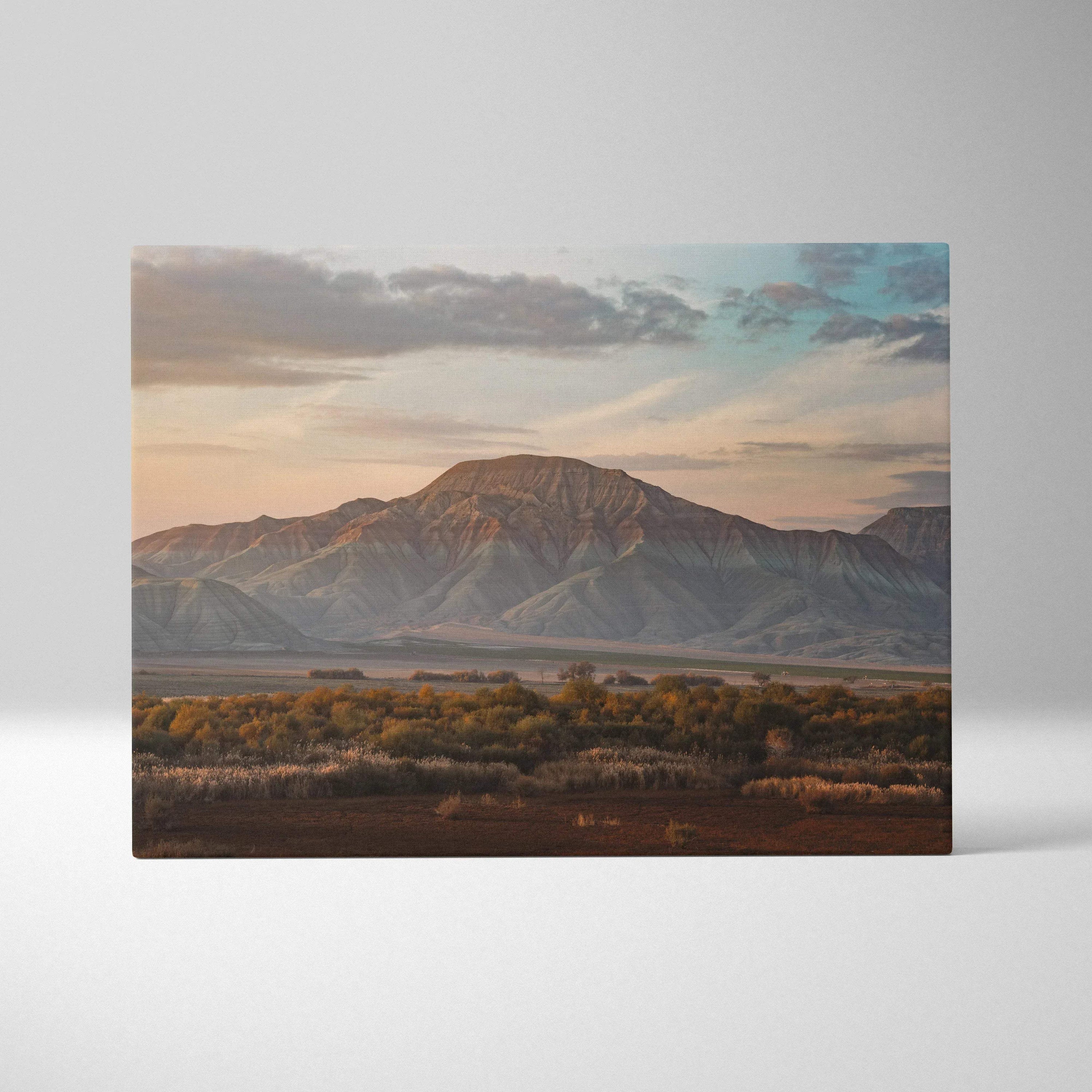 Majestic mountain desert landscape canvas wall art with warm sunset tones and layered hills.
