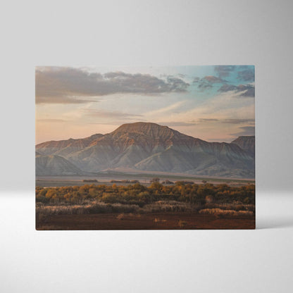 Majestic mountain desert landscape canvas wall art with warm sunset tones and layered hills.
